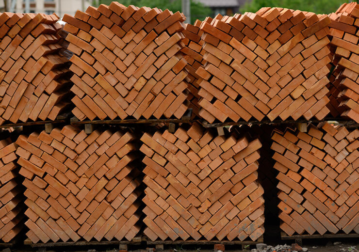 pallets and packages of freshly produced red bricks