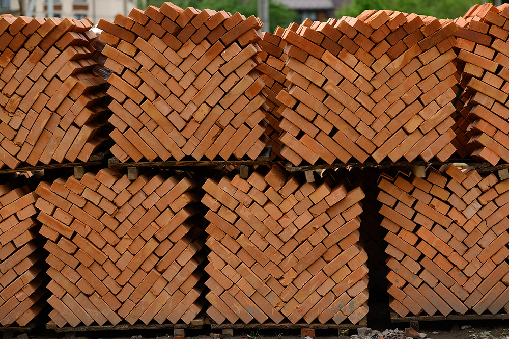 pallets and packages of freshly produced red bricks